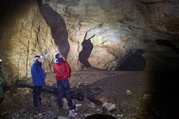Hikers family exploring a cave