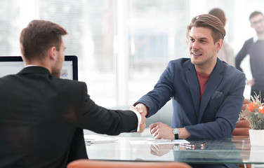 Businessmen shaking hands in conference room in office