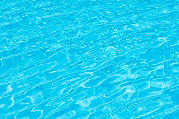 Ripple Water in swimming pool with sun reflection for background.