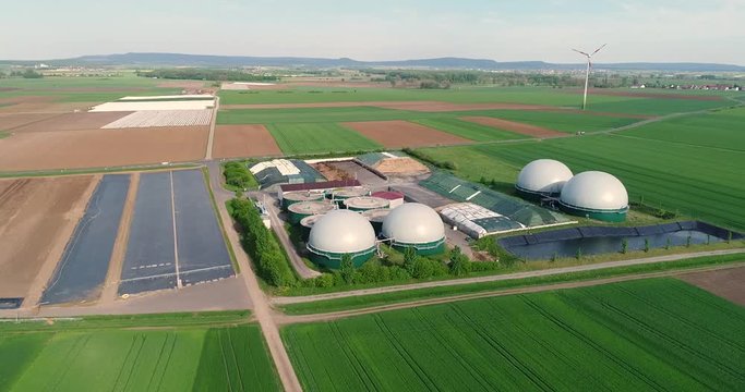 Camera flight over biogas plant from pig farm. Renewable energy from biomass. Modern agriculture European Union. aerial view, panoramic view from the air