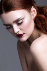 Fototapeta premium Beautiful young model with professional makeup, perfect skin, red lips