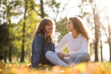 Mother and teenage daughter outdoor portrait