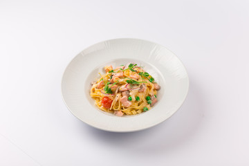 Front and top view isolated - Tagliatelle with salmon and tomatoes. 