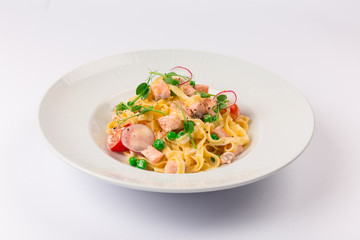 Front and top view isolated - Tagliatelle with salmon and tomatoes. 
