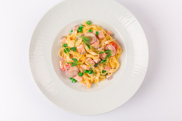 Front and top view isolated - Tagliatelle with salmon and tomatoes. 