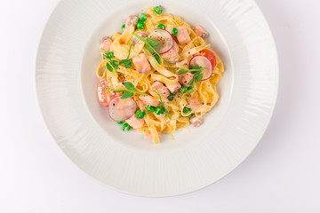 Front and top view isolated - Tagliatelle with salmon and tomatoes. 