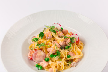 Front and top view isolated - Tagliatelle with salmon and tomatoes. 