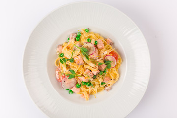 Front and top view isolated - Tagliatelle with salmon and tomatoes. 