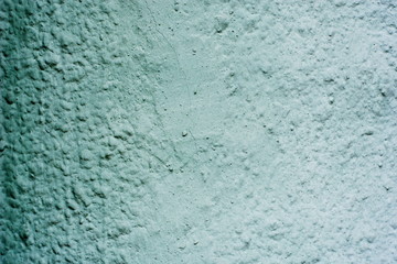 Background of a blue stucco coated and painted exterior, rough cast of cement and concrete wall texture