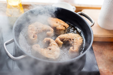 Pan with frying sturgeon fish. Outdoor kitchen. Summer barbeque and vacation