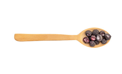 Wooden spoon with black raspberry on white background. Healthy eating. Top view.