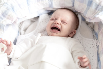 Baby girl crying in her crib © thodonal