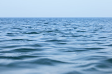 Surface of the sea with small waves. Seascape under a clear sky in a calm.