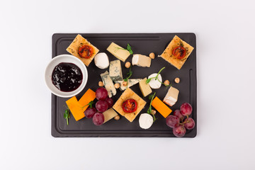 Top and Front View Isolated - Cheese plate with grapes, nuts, jam.