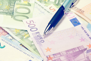 Ein Kugelschreiber und viele Euro Geldscheine
