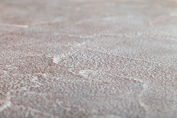 Fototapeta na wymiar Decorative plaster of a pleasant beige shade on a flat horizontal surface