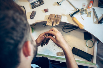 Different goldsmiths tools on the jewelry workplace. Jeweler at work in jewelry.
