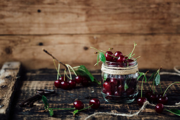 Fresh ripe cherries on a wooden table. Wooden background