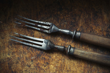 Old forks with wooden handles. Vintage objects