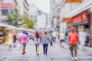 Crowd of anonymous people walking on busy city street
