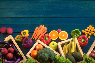 Flat lay of fresh  fruits and vegetables for background, Different fruits and vegetables for eating healthy, Colorful fruits and vegetables on blue plank background