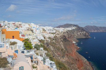 Fototapeta na wymiar Whitewashed Houses and Churches on Cliffs with Sea View in Oia, Santorini, Cyclades, Greece