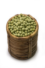 Green peas in cane basket isolated on white background