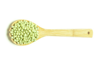 Green peas in wooden scoop spoon isolated on white background