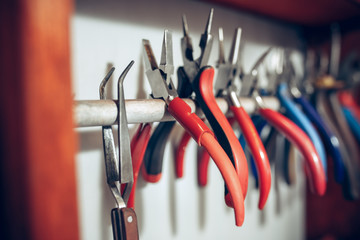 Different goldsmiths tools on the jewelry workplace. work in jewelry.