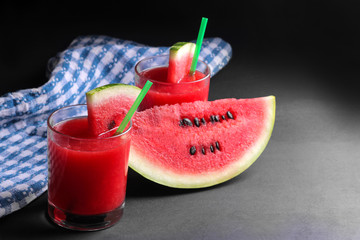 Watermelon smoothies with a fresh slice of ripe watermelon on a black background