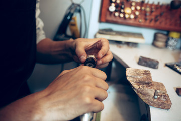 Different goldsmiths tools on the jewelry workplace. Jeweler at work in jewelry.