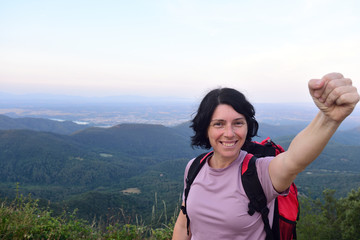 happy hiker woman to get to the top