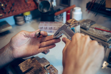 Different goldsmiths tools on the jewelry workplace. Jeweler at work in jewelry.
