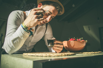 Guy drinking coffee and smoking a cigarette.