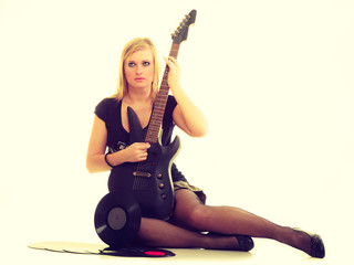 Woman with electrical guitar and vinyl record.