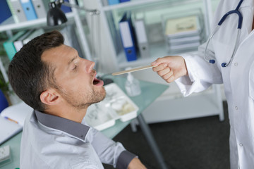 doctor examining a patient in her office