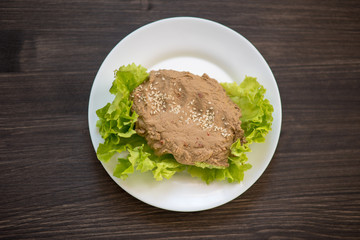 photo of a real meal on a dark background on a white plate.