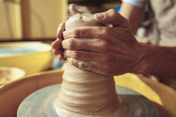 Creating a jar or vase of white clay close-up. Master crock.