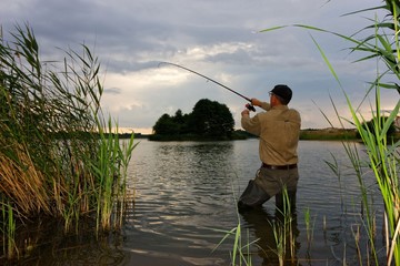 Angler catching the fish during stormy weather