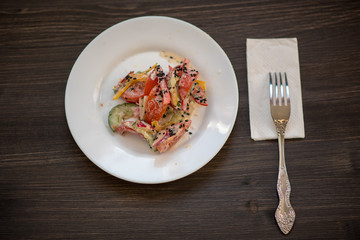 photo of a real meal on a dark background on a white plate.