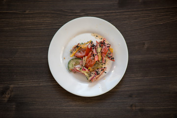 photo of a real meal on a dark background on a white plate.