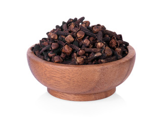 spicy dried clove, syzygium aromaticum flower buds in wooden bowl.
