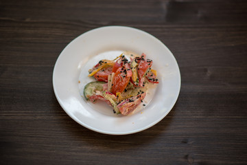 photo of a real meal on a dark background on a white plate.
