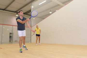 two happy indoor tennis players