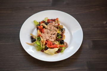 photo of a real meal on a dark background on a white plate.