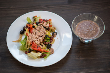photo of a real meal on a dark background on a white plate.