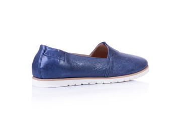 Women's blue slip-on shoeson white background with reflection. Fashion advertising shoes photos.