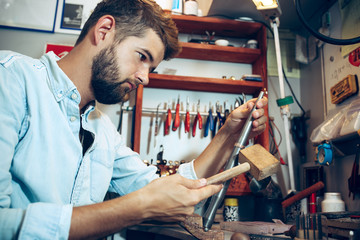 Different goldsmiths tools on the jewelry workplace. Jeweler at work in jewelry.