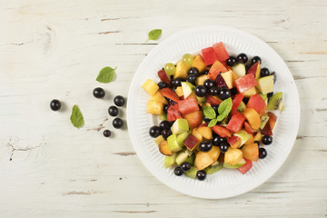 Mixed summer fruits salad top view