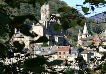 Village of Estaing seen through the foliage, Aveyron, France